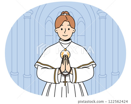 Little catholic girl takes part in first holy communion and stands in temple making prayer gesture 122562424