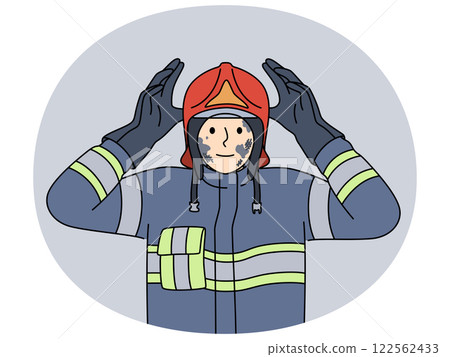 Man firefighter in uniform with traces of soot on face after extinguishing burning building 122562433