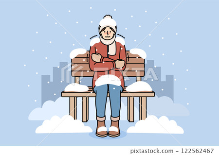 Freezing man sits on bench covered with snow due to lack of home and homeless shelters 122562467