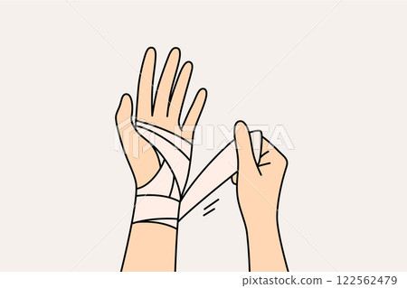 Wrapping bandage around injured arm of person who has suffered fracture or crack in bone 122562479