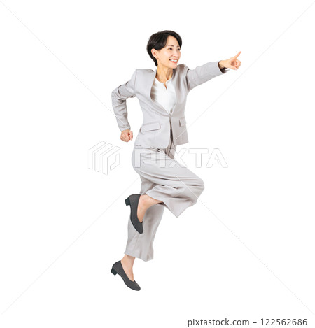 Middle-aged female business person jumping and pointing. Full-body photo PNG with transparent background precisely cut out by hand. 122562686