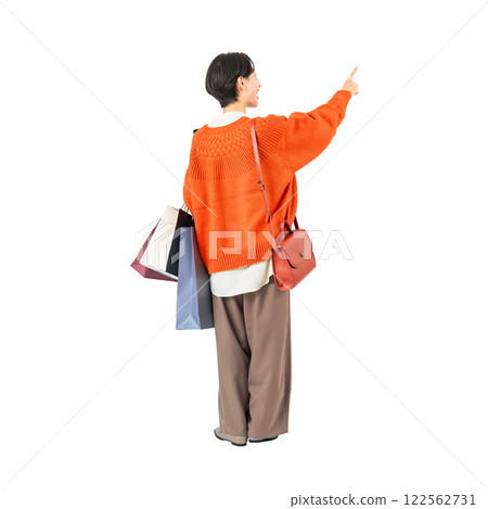 The back view of a middle-aged woman holding a shopping bag and pointing at it. A transparent full-body photo PNG precisely cut by hand 122562731