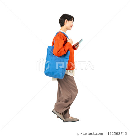 A stylish middle-aged woman walking with a smartphone. A transparent full-body photo PNG precisely cut by hand 122562743