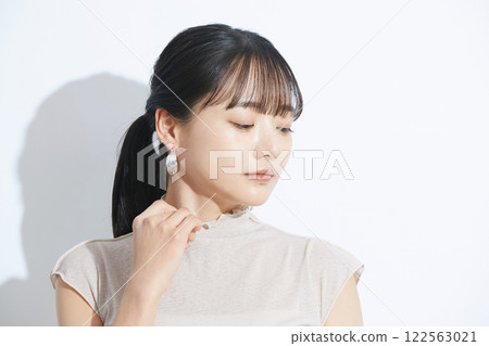 A refreshing beauty portrait of a young woman photographed against a light and shadow background A refreshing beauty portrait of a young woman photographed against a light and shadow background 122563021