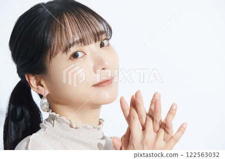 A refreshing beauty portrait of a young woman photographed against a light and shadow background A refreshing beauty portrait of a young woman photographed against a light and shadow background 122563032