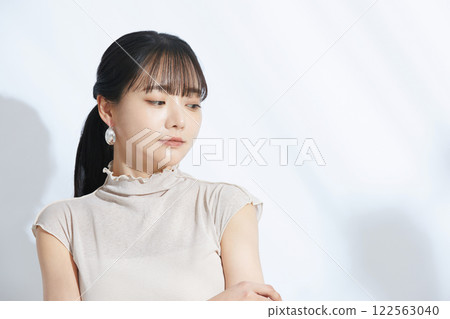 A refreshing beauty portrait of a young woman photographed against a light and shadow background A refreshing beauty portrait of a young woman photographed against a light and shadow background 122563040