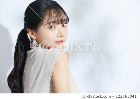 A refreshing beauty portrait of a young woman photographed against a light and shadow background A refreshing beauty portrait of a young woman photographed against a light and shadow background 122563041