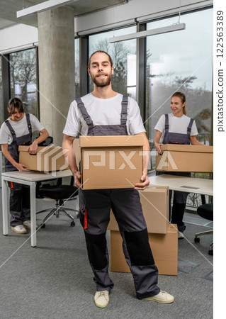 Bearded caucasain packaging center worker with a cardboard box in hands Bearded caucasain packaging center worker with a cardboard box in hands 122563389
