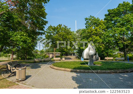 Montreal, Quebec, Canada - August 8 2021 : Iris artwork sculpture in Notre-Dame Island. Montreal, Quebec, Canada - August 8 2021 : Iris artwork sculpture in Notre-Dame Island. 122563523