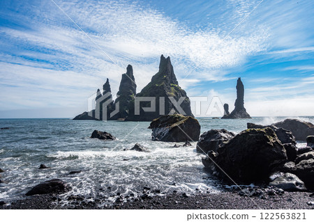 A collection of rocks that are positioned on the surface of a body of water A collection of rocks that are positioned on the surface of a body of water 122563821