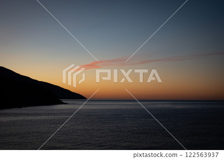 A stunning sunset over a calm Mediterranean sea. Mount Athos. Greece. A stunning sunset over a calm Mediterranean sea. Mount Athos. Greece. 122563937