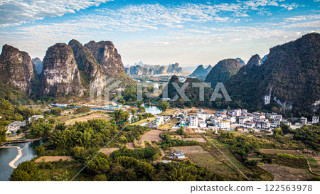 Aerial view of a scenic valley among majestic mountains and a river 122563978