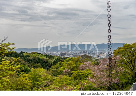 Kyoto view from a hill, with trees and mountains behind. Falling chain. Japan 122564047