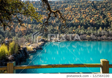 A charming wooden fence overlooks Blue Moon Lake in Yunnan, China. A charming wooden fence overlooks Blue Moon Lake in Yunnan, China. 122564100