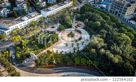 Aerial view of a park with trees and buildings in the background Aerial view of a park with trees and buildings in the background 122564102
