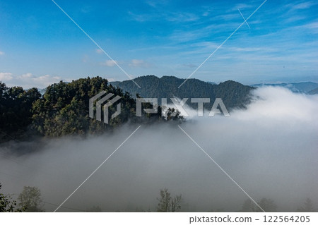 Beautiful view of the majestic Slovenia mountains covered in fog on a sunny day 122564205