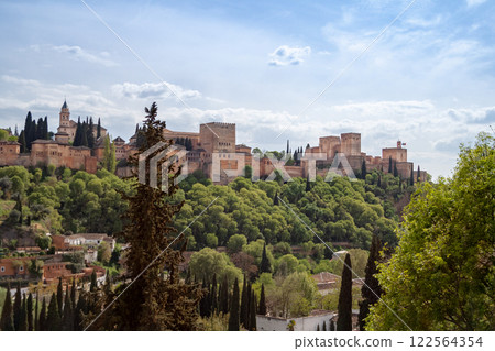 Behold the Alhambra Palace, an iconic landmark surrounded by greenery. Spain. 122564354