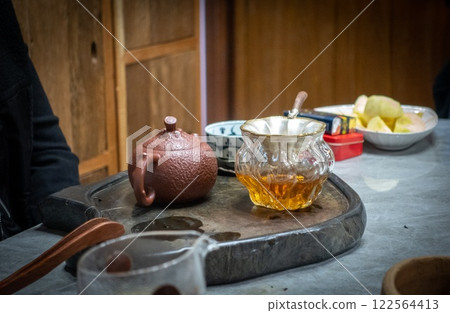 Tea ceremony near Lijiang: teapot alongside a cup of tea. Yunnan, China. Tea ceremony near Lijiang: teapot alongside a cup of tea. Yunnan, China. 122564413