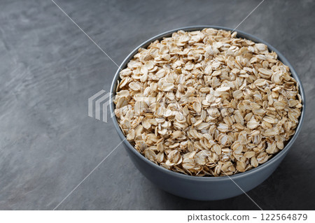 Oat Flakes in Bowl on Dark Gray Background, Copy Space 122564879