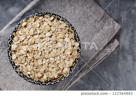 Raw Rolled Oats on Gray Background, Healthy Eating Concept, Copy Space, Top View Raw Rolled Oats on Gray Background, Healthy Eating Concept, Copy Space, Top View 122564883
