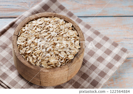 Raw Rolled Oats in Wooden Bowl, Healthy Eating Concept, Copy Space Raw Rolled Oats in Wooden Bowl, Healthy Eating Concept, Copy Space 122564884