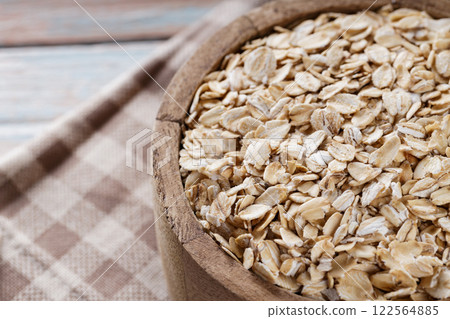 Raw Rolled Oats in Wooden Bowl, Healthy Eating Concept, Copy Space Raw Rolled Oats in Wooden Bowl, Healthy Eating Concept, Copy Space 122564885