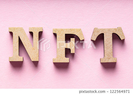 NFT Inscription on Pink Background, Non-Fungible Token Concept, Close-Up NFT Inscription on Pink Background, Non-Fungible Token Concept, Close-Up 122564971