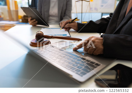 Business people and lawyers discussing contract papers sitting in the table at office in the morning. concepts of law, advice, legal services. Business people and lawyers discussing contract papers sitting in the table at office in the morning. concepts of law, advice, legal services. 122565332