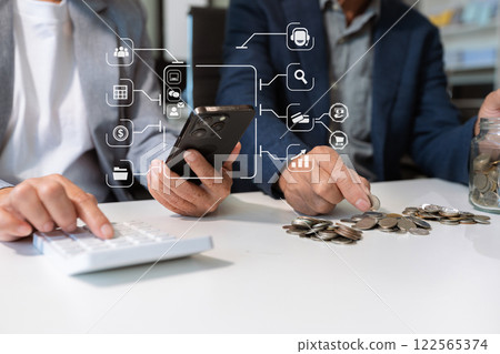 concept with saving money, accountant working on desk in home using calculator and laptop to calculate budget. concept with saving money, accountant working on desk in home using calculator and laptop to calculate budget. 122565374
