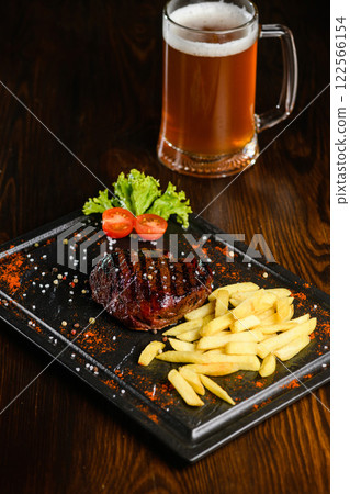 Grilled Steak with French Fries and Beer Grilled Steak with French Fries and Beer 122566154