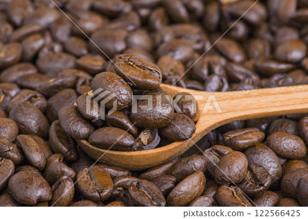Roasted coffee beans in a wooden spoon. 122566425