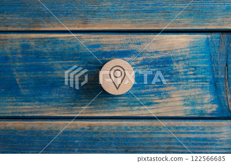 Wooden cut circle with a location icon on it Wooden cut circle with a location icon on it 122566685