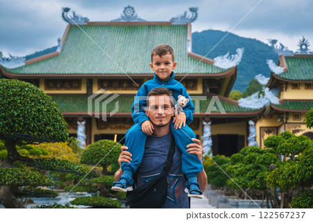 family of tourists dad and son at Buddhist temple at Linh Ung Pagoda in Da Nang in Vietnam. Travel and tourism in Asia family of tourists dad and son at Buddhist temple at Linh Ung Pagoda in Da Nang in Vietnam. Travel and tourism in Asia 122567237