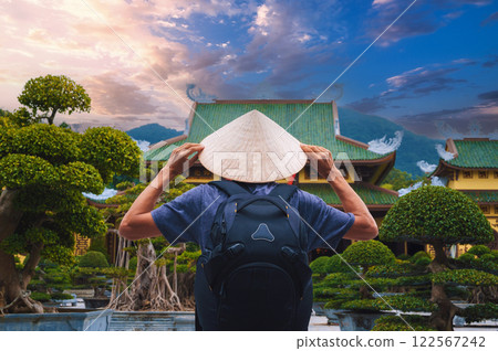 back of male tourist traveler at Buddhist temple at Linh Ung Pagoda in Da Nang in Vietnam. Concept of travel and tourism in Asia 122567242