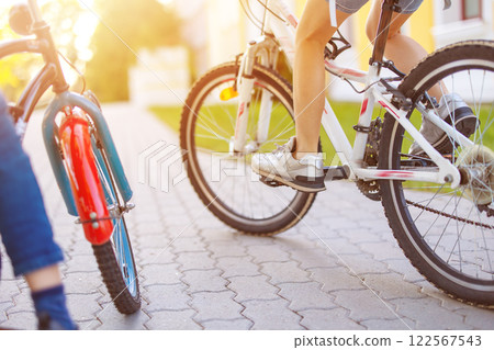 Children on the bicycles riding together in the morning. 122567543