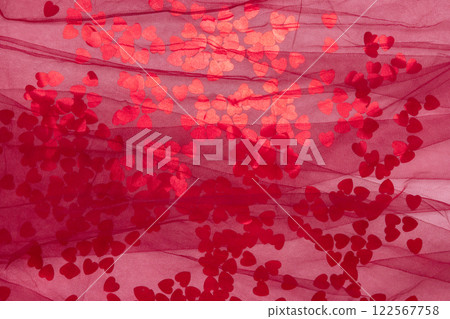 red metallic heart confetti on pink background with burgundy mesh. Minimalist holiday background for valentines red metallic heart confetti on pink background with burgundy mesh. Minimalist holiday background for valentines 122567758