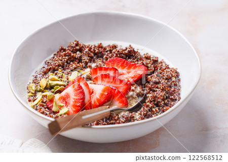 Breakfast quinoa bowl with strawberries and pistachio. Breakfast quinoa bowl with strawberries and pistachio. 122568512