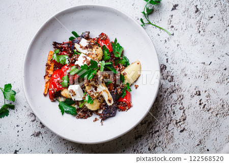 Warm quinoa salad with roasted vegetables and feta. 122568520