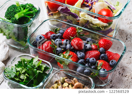 Healthy vegan food preparations for week in glass containers. Vegetables, nuts, berries in boxes. Healthy vegan food preparations for week in glass containers. Vegetables, nuts, berries in boxes. 122568529