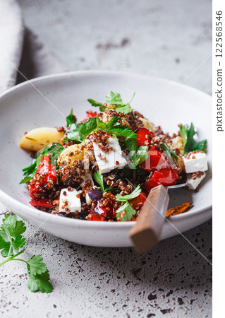 Warm quinoa salad with roasted vegetables and feta. Warm quinoa salad with roasted vegetables and feta. 122568546