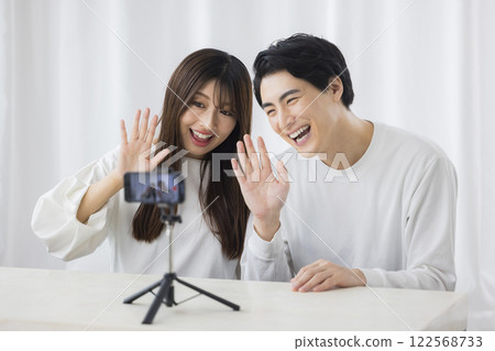 A couple looking at a smartphone A couple looking at a smartphone 122568733