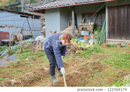 Woman working in the fields, country life, home garden 122569174