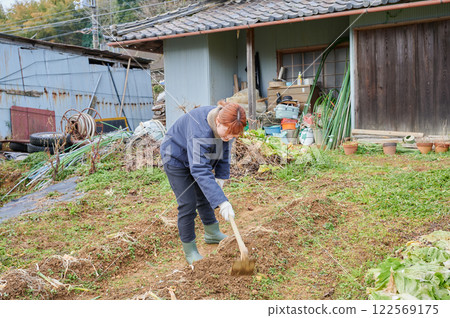 Woman working in the fields, country life, home garden Woman working in the fields, country life, home garden 122569175
