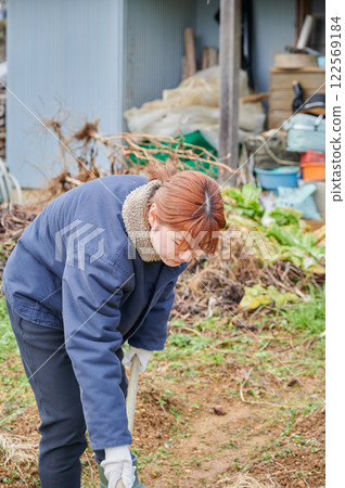 Woman working in the fields, country life, home garden 122569184