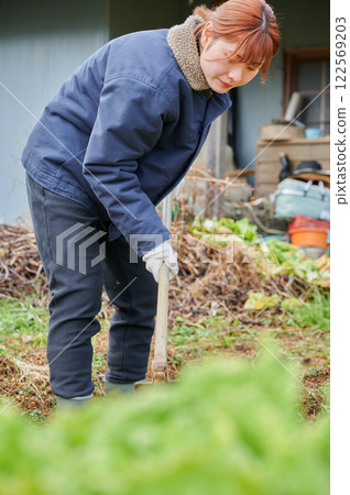 Woman working in the fields, country life, home garden 122569203