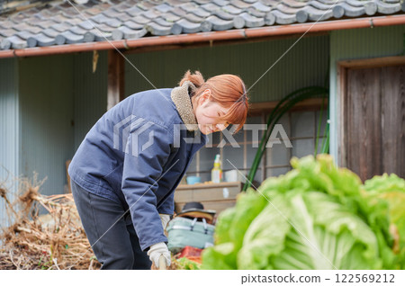 Woman working in the fields, country life, home garden 122569212
