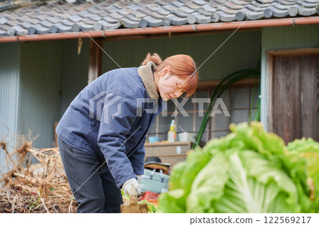 Woman working in the fields, country life, home garden Woman working in the fields, country life, home garden 122569217