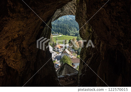 Captivating view of village from deep inside Predjama Castle Cave. Slovenia Captivating view of village from deep inside Predjama Castle Cave. Slovenia 122570015