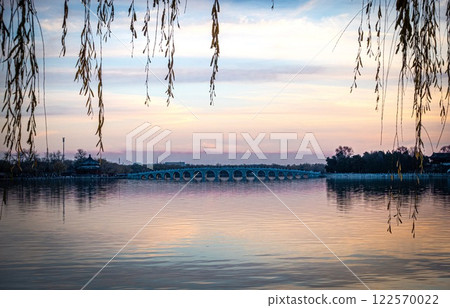 Summer Palace. Beijing stunning purple dusk with bridge and branches. China 122570022