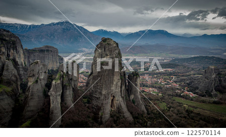 Meteora rock formations with Kalambata in the back in a winter day. Greece Meteora rock formations with Kalambata in the back in a winter day. Greece 122570114